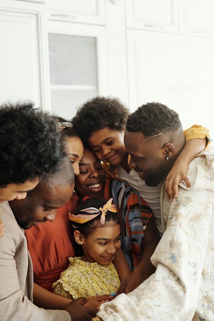 A family spending quality time together in a relaxed home environment, demonstrating a safe and supportive space for mental health conversations.