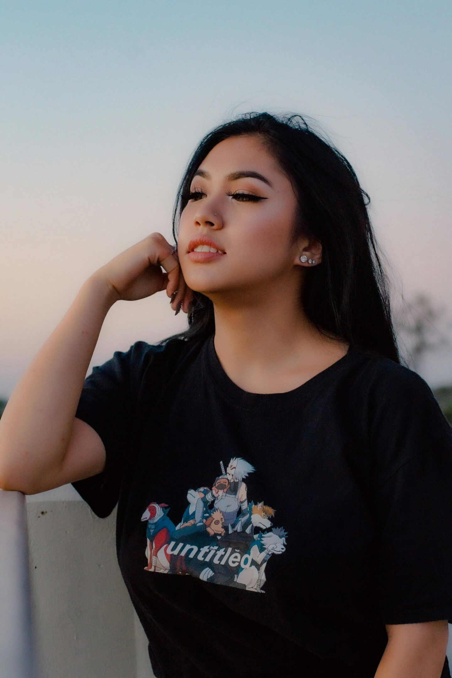 Teen sitting alone in nature at sunset, reflecting and finding peace during emotional recovery from trauma.