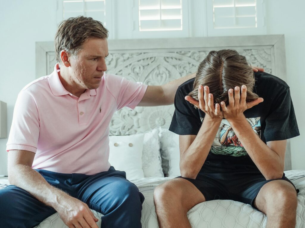 A parent gently listening to their teen share feelings of anxiety or stress, fostering trust and understanding.