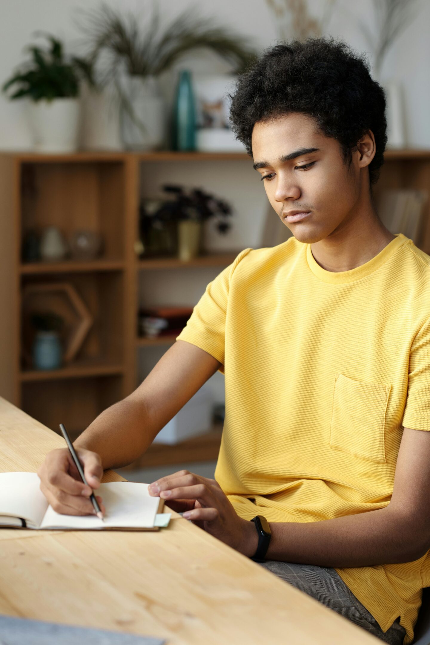 A teen quietly working through a DBT skills workbook to manage emotions and reduce stress.