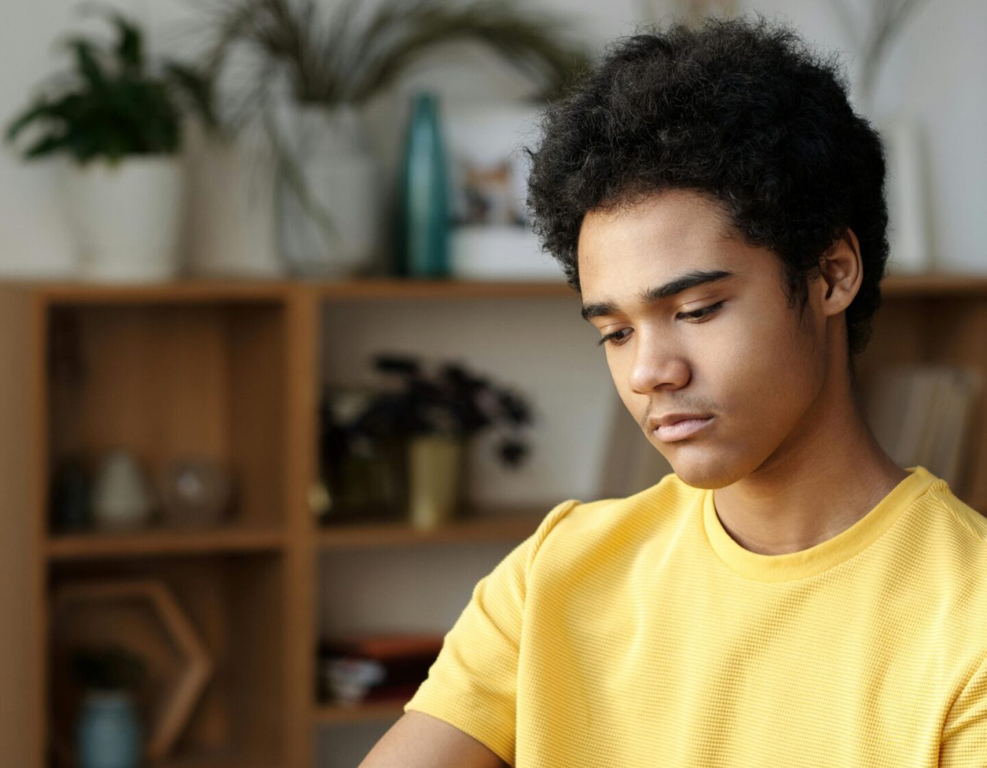 A teen quietly working through a DBT skills workbook to manage emotions and reduce stress.