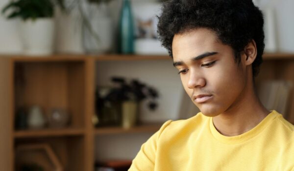 A teen quietly working through a DBT skills workbook to manage emotions and reduce stress.