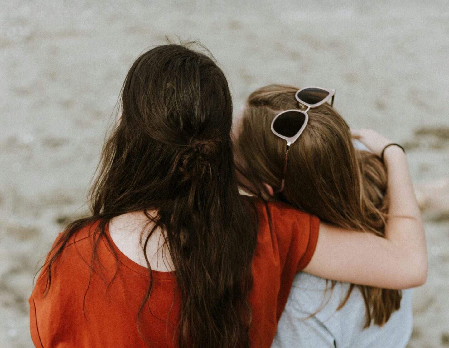 A teen friend comforting a student who appears upset, representing support after bullying and youth mental health awareness.