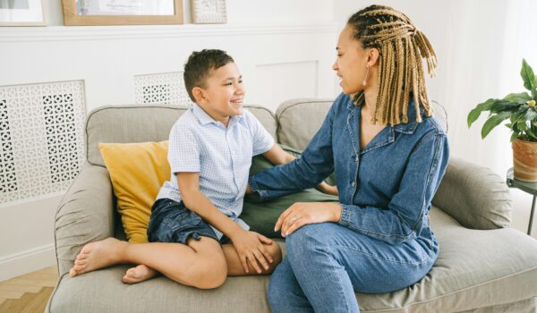A parent and teen sitting together having an open and supportive conversation about relationships.