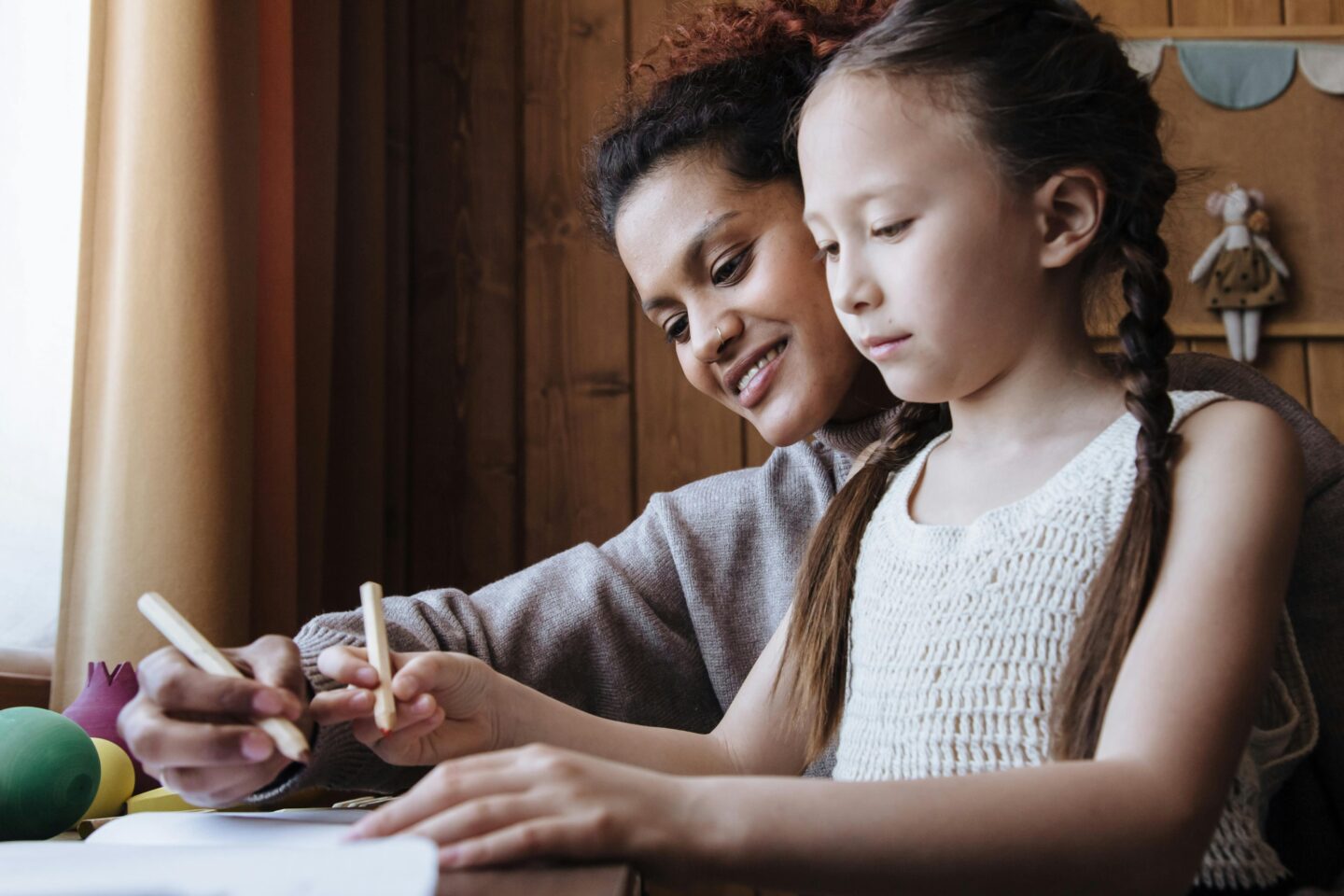 A child and parent writing down in a planner preparing for back-to-school.