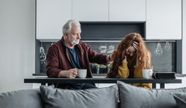 Parent talking supportively with teen about mental health.