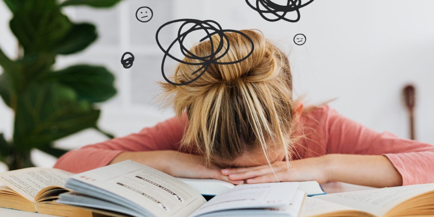 Student overwhelmed by schoolwork, head down on a stack of open books, with illustrated scribbles and worried expressions above representing racing thoughts and difficulty focusing.